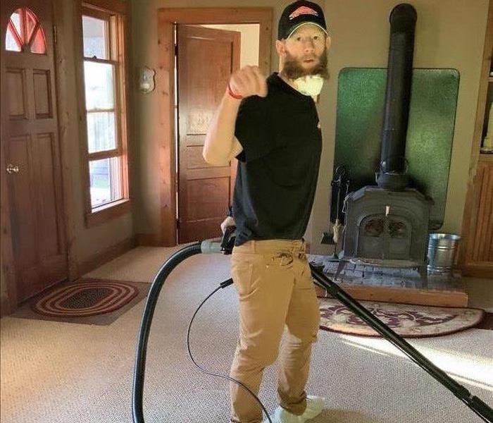 Tyler is vacuuming carpet with steam cleaner after a fire extinguisher deployed. 