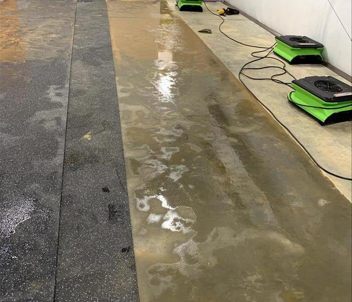 Sitting water on a concrete floor with rubber mats. 